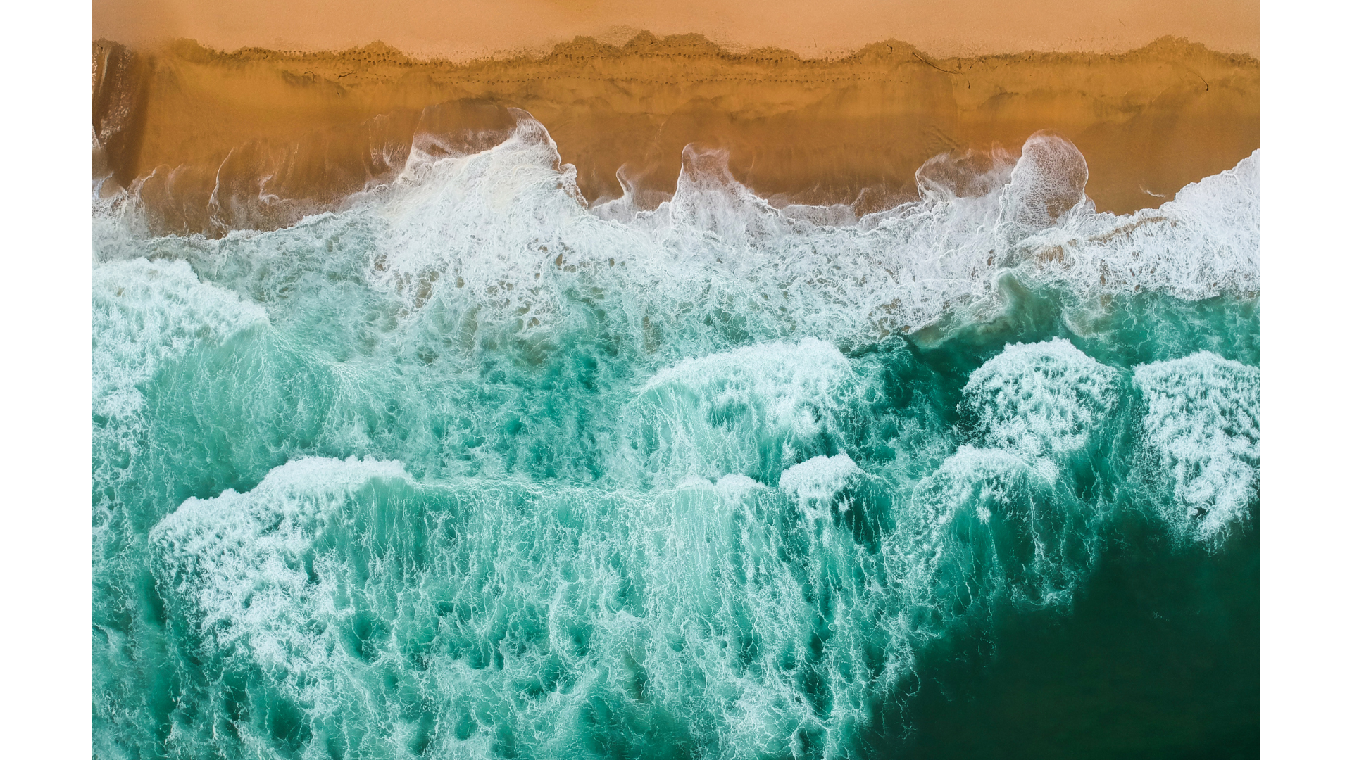 Waves crashing on a beach demonstrating a high volume