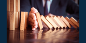 A hand intervening to stop more blocks from falling