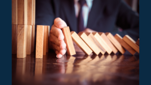 A hand intervening to stop more blocks from falling